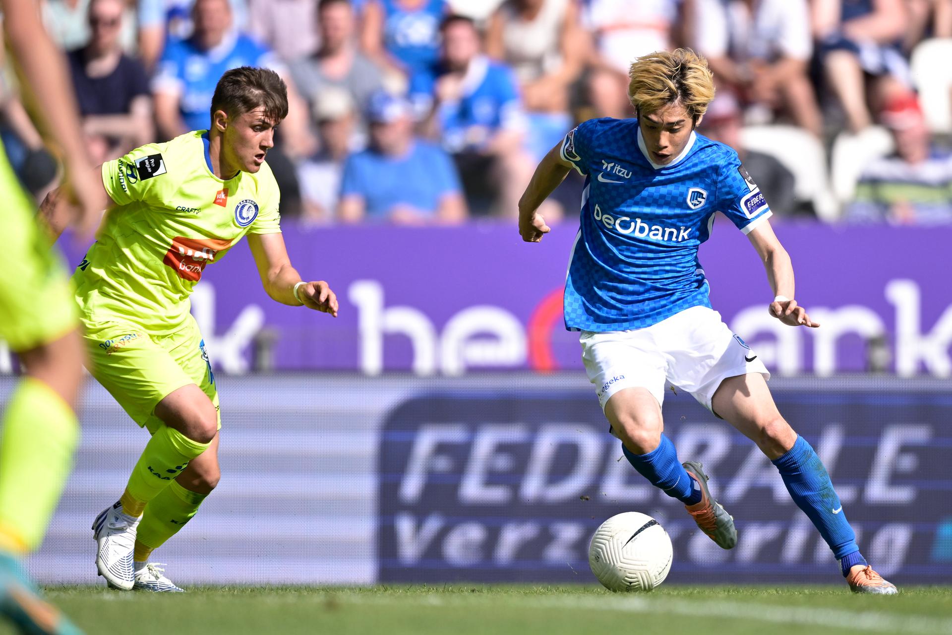 Genk's Junya Ito (R) fights for the ball during a soccer match between KRC Genk and KAA Gent, Sunday 15 May 2022 in Genk, on day 5 of the 'Europe play-off' of the 2021-2022 'Jupiler Pro League' first division of the Belgian championship. BELGA PHOTO JOHAN EYCKENS