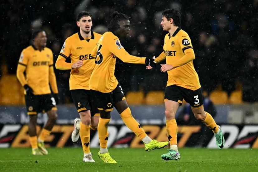 Wolverhampton Wanderers' Spanish defender #03 Hugo Bueno (R) celebrates scoring the team's first goal during the English Premier League football match between Wolverhampton Wanderers and Arsenal at the Molineux stadium in Wolverhampton, central England on February 18, 2026.  Paul ELLIS / AFP