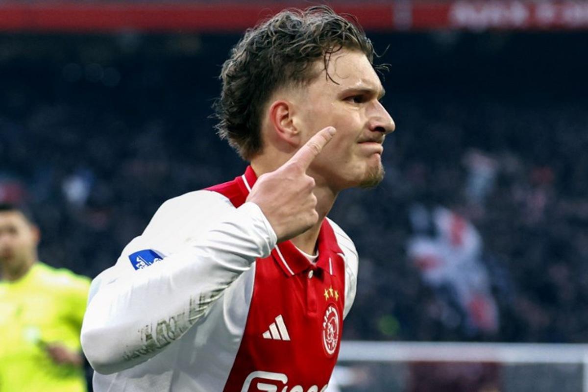 Ajax's Belgian forward #11 Mika Godts celebrates after scoring his team's first goal during the Dutch Eredivisie football match between Ajax Amsterdam and Heracles Amelo at the Johan Cruijff ArenA in Amsterdam on February 16, 2025.  MAURICE VAN STEEN / ANP / AFP