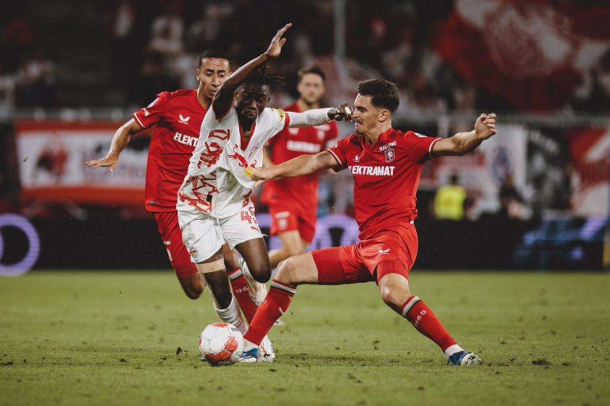 Salzburg's Dorgeles Nene and FC Twente's Alec Van Hoorenbeeck vie for the ball during the UEFA Champions League qualification football match between Salzburg and Twente in Salzburg, on August 6, 2024.  EXPA / JFK / APA / AFP
