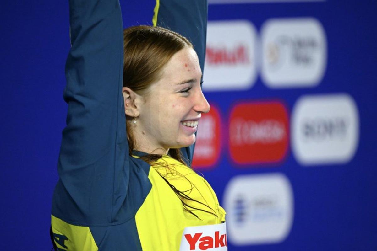 Australia's swimmer Mollie O'Callaghan celebrates on the podium of the women's 100m freestyle swimming event during the 2025 World Aquatics Championships in Singapore on August 1, 2025.  François-Xavier MARIT / AFP