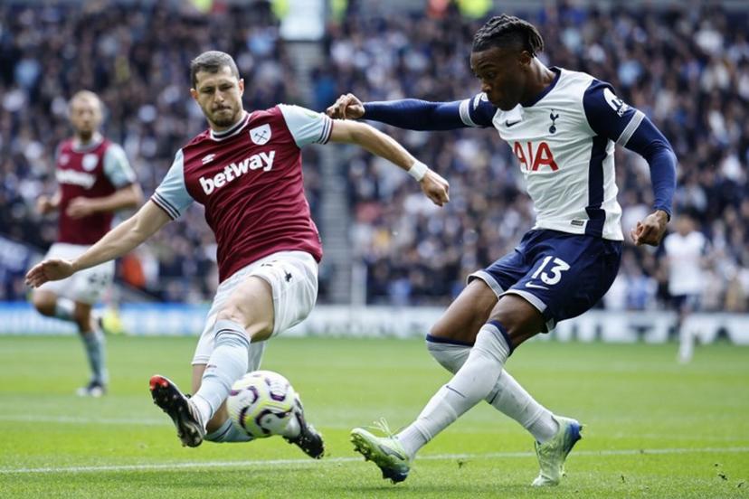 Tottenham Hotspur's Italian defender #13 Destiny Udogie (R) crosses the ball past West Ham's Argentinian midfielder #24 Guido Rodriguez (L) during the English Premier League football match between Tottenham Hotspur and West Ham United at the Tottenham Hotspur Stadium in London, on October 19, 2024.  BENJAMIN CREMEL / AFP