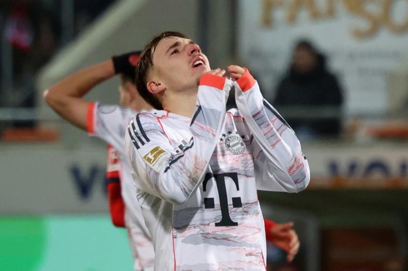 Bayern Munich's German midfielder #42 Lennart Karl reacts during the German first division Bundesliga football match between  FC Heidenheim and FC Bayern Munich in Heidenheim, southern Germany, on December 21, 2025.   Karl-Josef HILDENBRAND / AFP