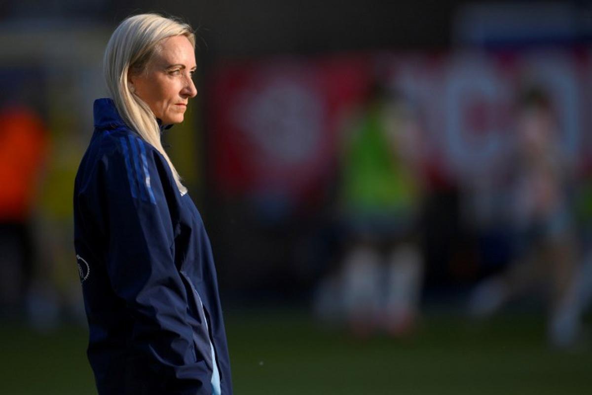 Belgium's Icelandic coach Elisabet Gunnarsdottir stands on the pitch as her players warm up before the start of the UEFA Women's Nations League group A3 football match between Belgium and Spain at the King Power at Den Dreef Stadium, in Leuven on May 30, 2025.  JOHN THYS / AFP
