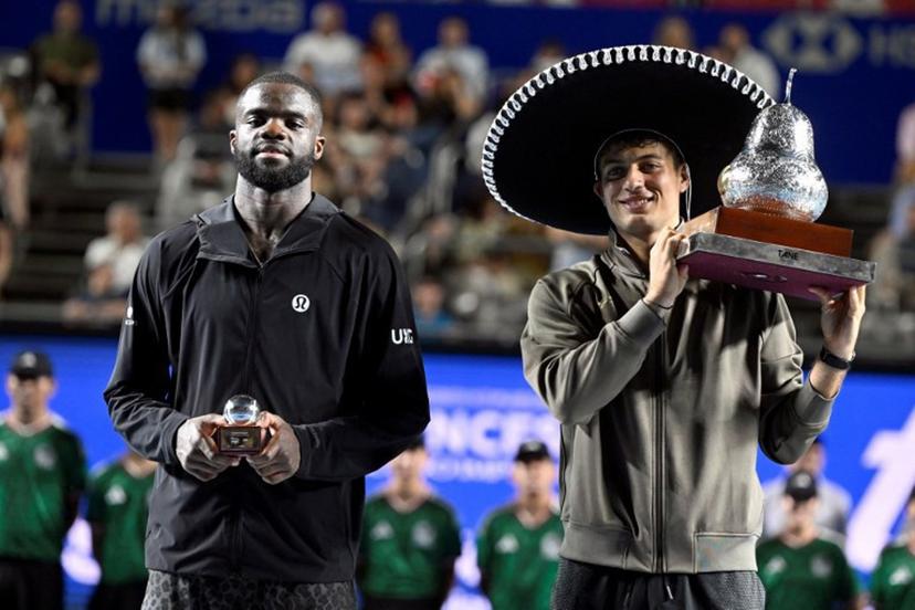 Italy's Flavio Cobolli (R) poses with his trophy after defeating US' Frances Tiafoe (L) during the 2026 Mexico ATP 500 Tennis Open men's singles tennis final match at the Arena GNP Seguros in Acapulco, Guerrero State, Mexico on February 28, 2026.  Alfredo ESTRELLA / AFP