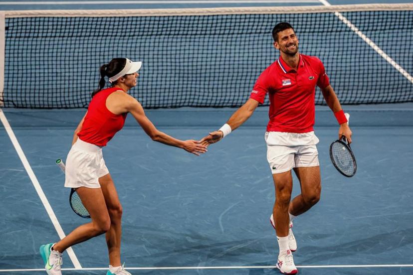 Serbia's Olga Danilovic and Novak Djokovic (R) greet each other while playing against China's Qinwen Zheng and Zhang Zhizhen during their doubles match at the United Cup tennis tournament in Perth on December 31, 2023.  COLIN MURTY / AFP