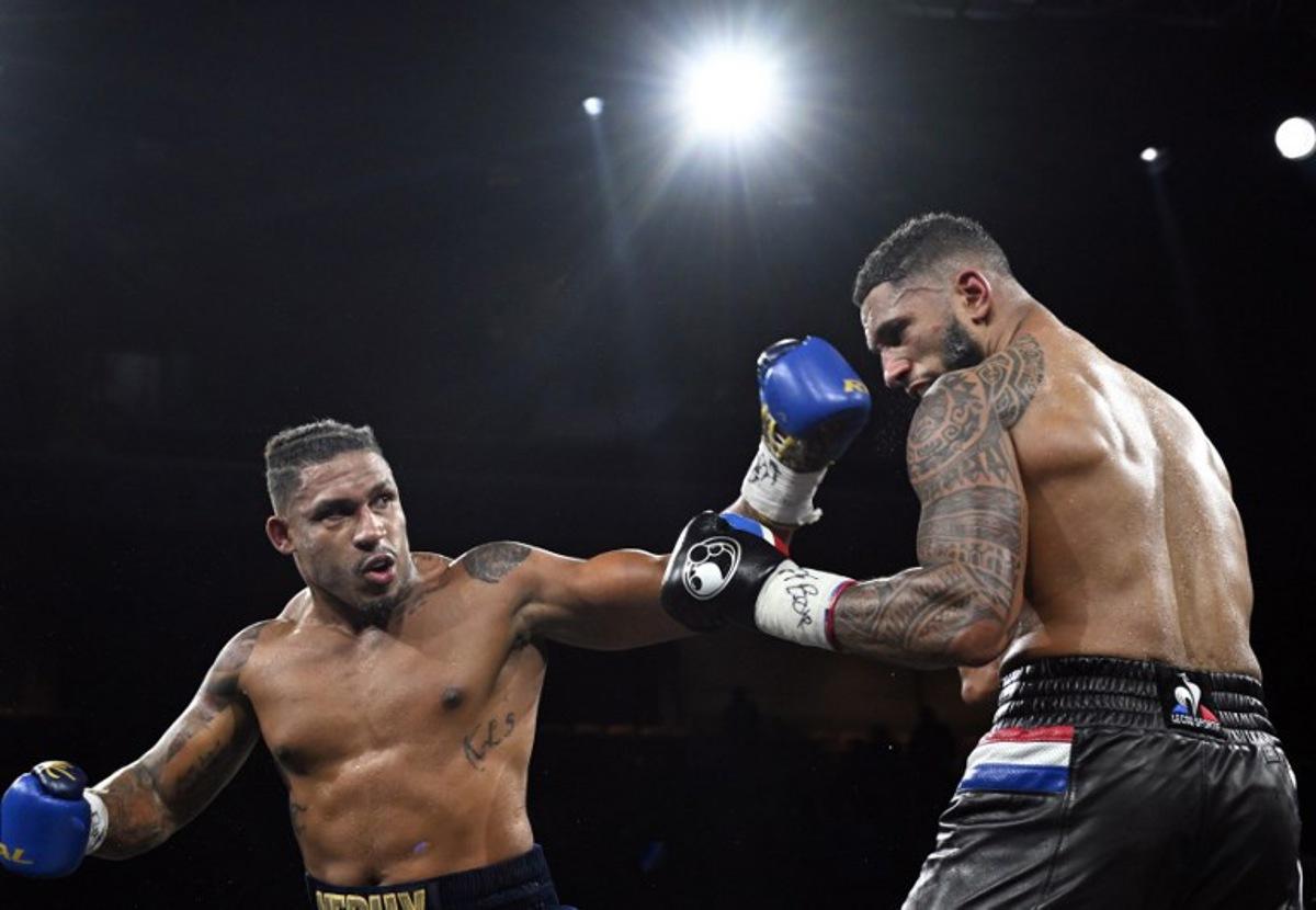 France's Tony Yoka (R) competes against Belgium's Ryad Merhy in their International Heavyweight boxing bout at the Roland Garros complex in western Paris, on December 9, 2023.   Miguel MEDINA / AFP
