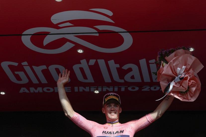 Lidl-Trek's Danish rider Mads Pedersen, wearing the overall leader's pink jersey (Maglia Rosa), celebrates on the podium after the 4th stage of the 108th Giro d'Italia cycling race 189kms from Alberobello to Lecce on May 13, 2025.  Luca Bettini / AFP