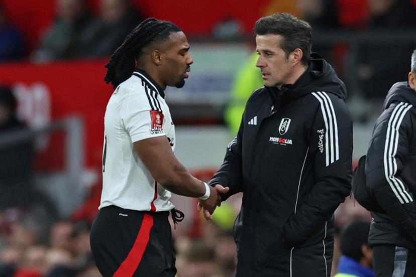 Fulham's Spanish midfielder #11 Adama Traore (L) shakes hands with Fulham's Portuguese head coach Marco Silva (R) as he leaves the game, injured during the English FA Cup fifth round football match between Manchester United and Fulham at Old Trafford in Manchester, north west England, on March 2, 2025.   Darren Staples / AFP