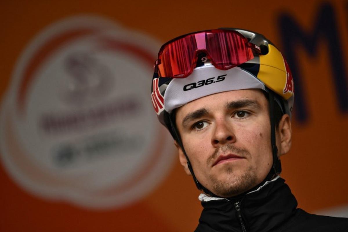 Team Q36.5's British rider Thomas Pidcock stands on stage before the start of the Milan - Sanremo one-day classic cycling race, in Pavia, near Milan, on March 22, 2025.  Marco BERTORELLO / AFP