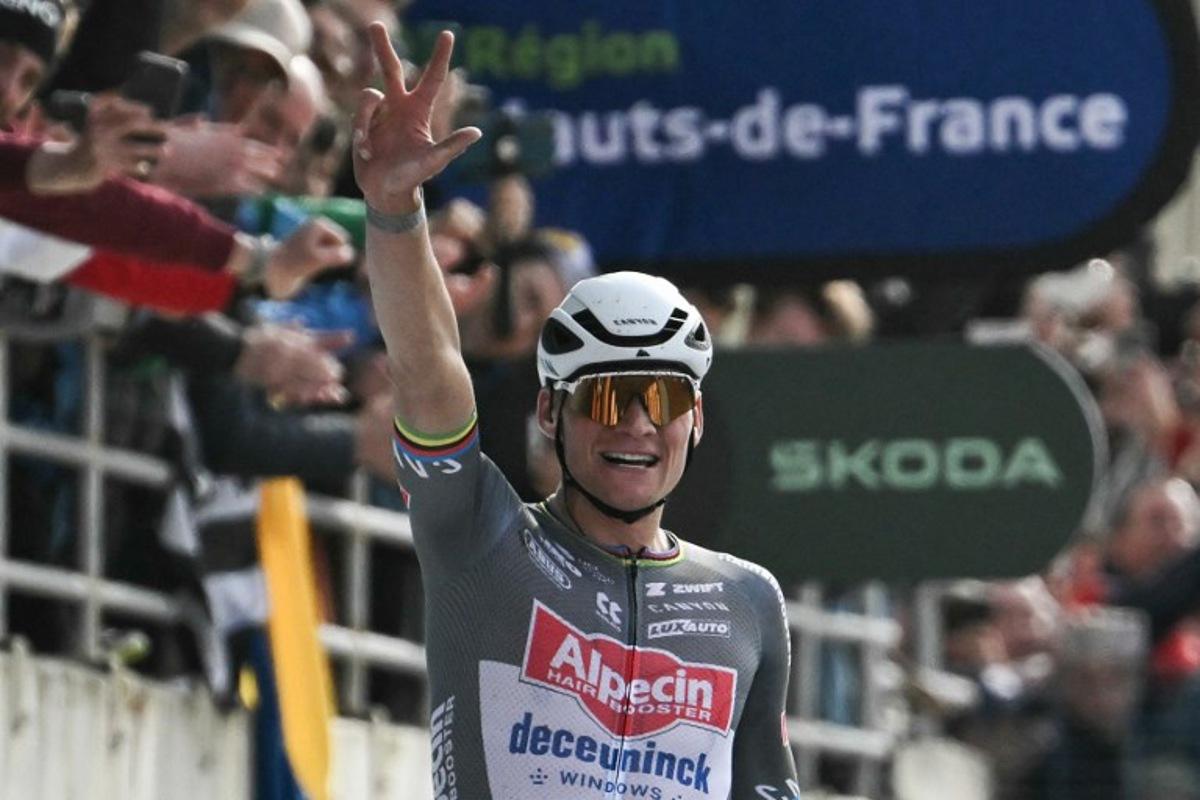 Alpecin-Deceuninck's Dutch rider Mathieu van der Poel gestures representing the number three as he celebrates after crossing the finish line to win the 122nd edition of the Paris-Roubaix one-day classic cycling race, 259,2 km between Compiegne and Roubaix, at the Vélodrome André-Pétrieux in Roubaix, northern France on April 13, 2025. Mathieu van der Poel won cycling's Paris-Roubaix for a third straight time on April 13, 2025 edging Tour de France champion Pogacar in the race nick-named 'The Hell of the North'. Jeff PACHOUD / AFP