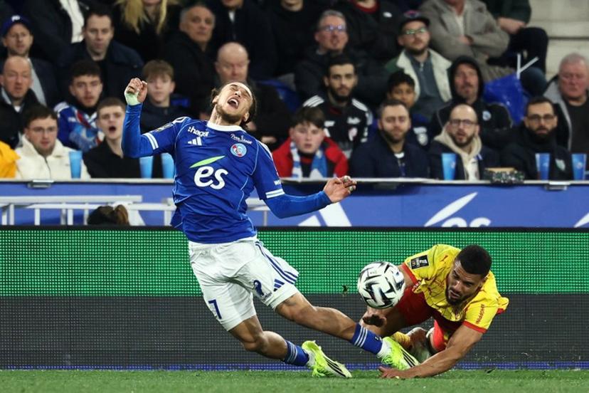 Lens' French defender #14 Matthieu Udol (R) fights for the ball with Strasbourg's Belgian midfielder #07 Diego Moreira during the French L1 football match between RC Strasbourg Alsace and Lens (RCL) at the Stade de la Meinau in Strasbourg, eastern France, on February 27, 2026.   Frederick FLORIN / AFP