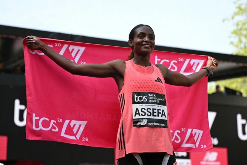 Ethiopia's Tigst Assefa poses after crossing the line to win the women's race in a new women's only world record at the 2026 London Marathon in central London on April 26, 2026.  JUSTIN TALLIS / AFP