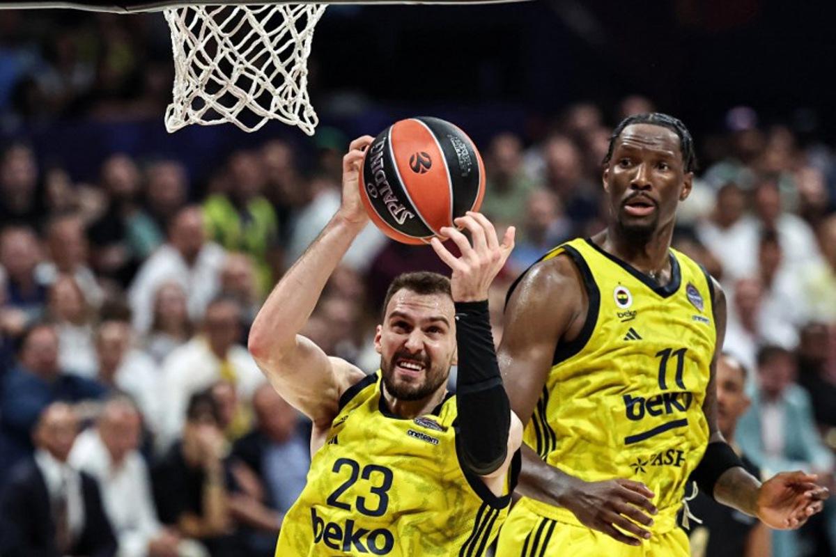Fenerbahce's Serbian forward #23 Marko Guduric catches the ball during the Euroleague Basketball final match between Fenerbahce Beko Istanbul and AS Monaco at Etihad Arena in Abu Dhabi on May 25, 2025.  Fadel SENNA / AFP