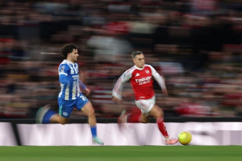 Arsenal's Belgian midfielder #19 Leandro Trossard (R) is chased by Brighton's Turkish defender #24 Ferdi Kadioglu (L) during the English Premier League football match between Arsenal and Brighton and Hove Albion at the Emirates Stadium in London on December 27, 2025.   Adrian Dennis / AFP