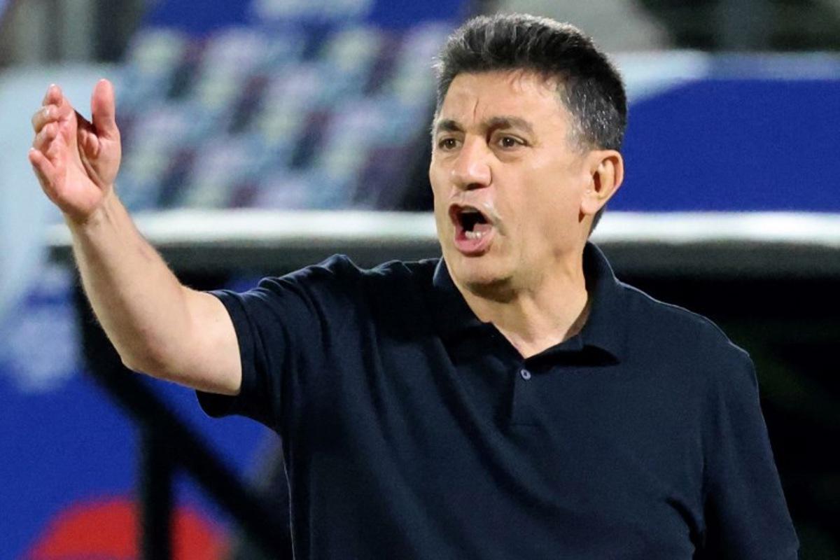 Iran's coach Amir Ghalenoei speaks to his players during the FIFA World Cup 2026 Asia zone qualifiers group A football match between Iran and the North Korea at the Azadi Sports Complex in Tehran on June 10, 2025.  ATTA KENARE / AFP