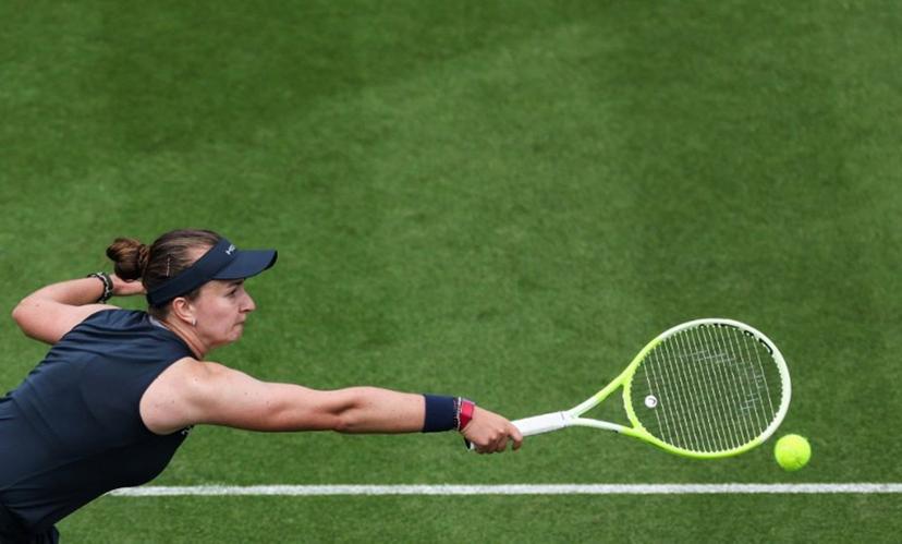 Czech Republic's Barbora Krejcikova plays a backhand return to Britain's Jodie Burrage during their women's singles round of 16 tennis match on day three at the Rothesay Eastbourne International tennis tournament in Eastbourne, southern England, on June 25, 2025.  Adrian Dennis / AFP