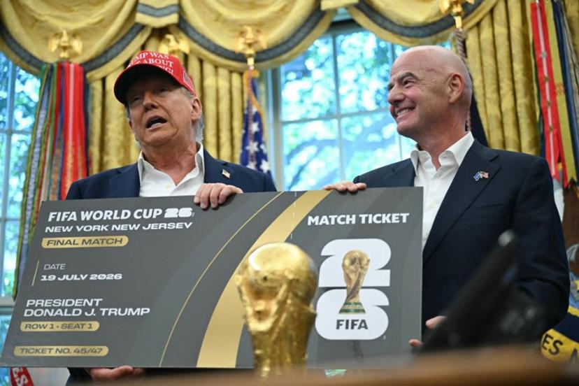 US President Donald Trump makes an announcement from the Oval Office of the White House in Washington, DC, on August 22, 2025 next to FIFA president Gianni Infantino (R). Trump announced the 2026 World Cup draw will be held on December 5 at Washington's Kennedy Center. ANDREW CABALLERO-REYNOLDS / AFP