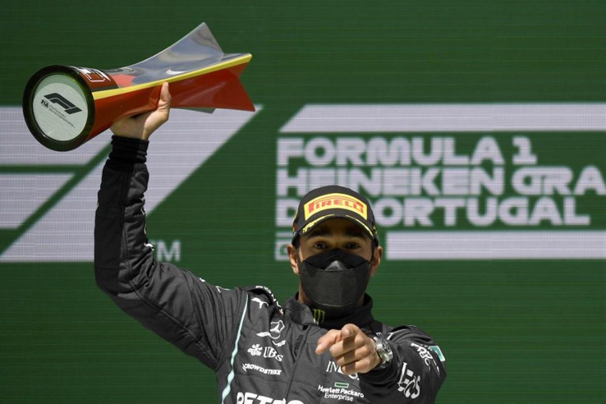 Mercedes' British driver Lewis Hamilton celebrates on the podium after winning the Portuguese Formula One Grand Prix race at the Algarve International Circuit in Portimao on May 2, 2021.   GABRIEL BOUYS / POOL / AFP