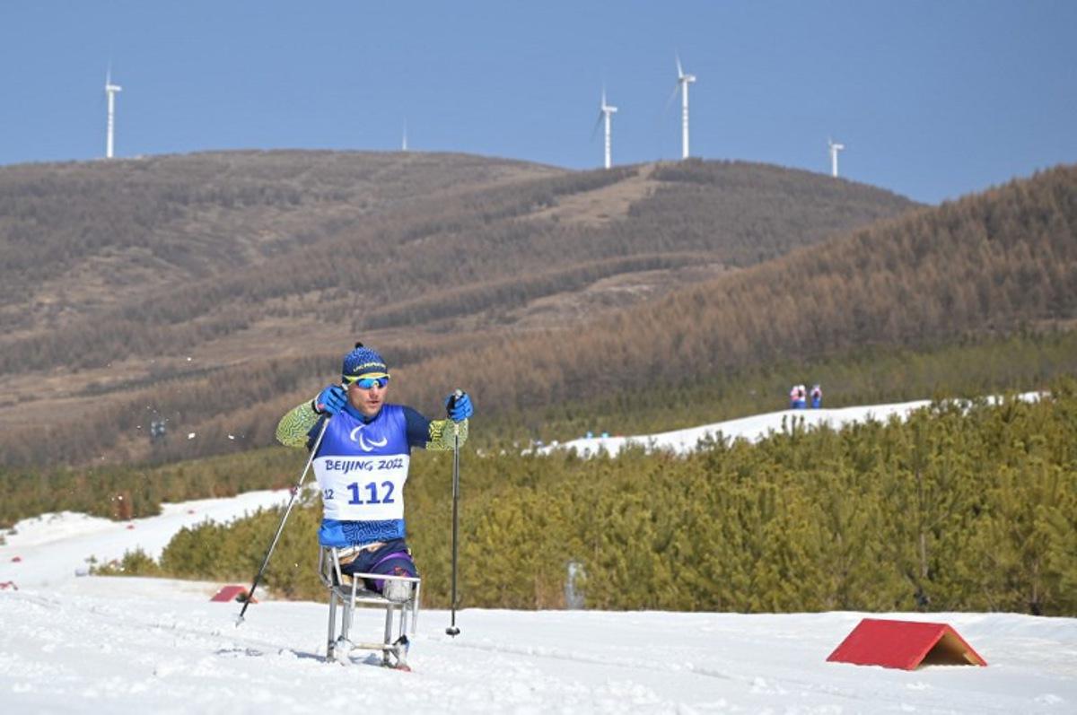 Ukraine's Pavlo Bal competes in the men's middle distance sitting para cross-country skiing final event on March 12, 2022, at the Zhangjiakou National Biathlon Centre during the Beijing 2022 Winter Paralympic Games.  Mohd RASFAN / AFP