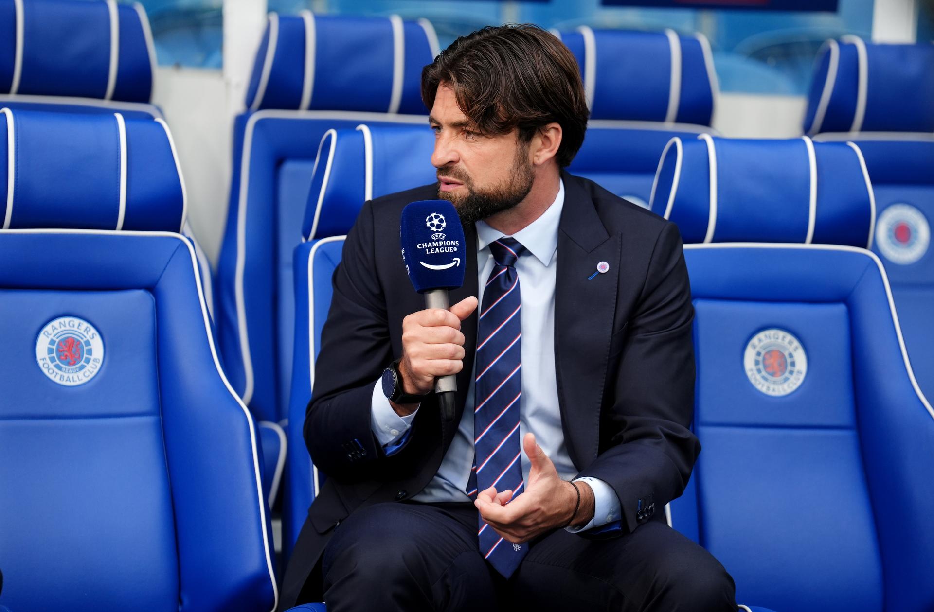 Rangers manager Russell Martin gives an television interview from the bench ahead of the UEFA Champions League, play-off, first leg match at Ibrox Stadium, Glasgow. Picture date: Tuesday August 19, 2025. BELGIUM ONLY