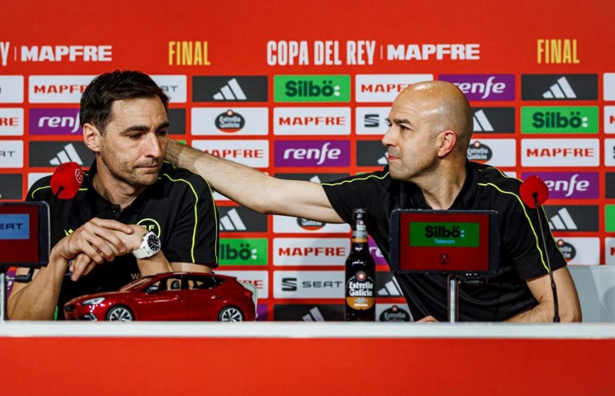 This handout picture taken and released by the Spanish Royal Football Federation (RFEF) on April 25, 2025 shows Spanish referee Pablo Gonzalez Fuertes (R) comforting Spanish referee Ricardo De Burgos Bengoechea during a press conference ahead of the King's Cup final, at La Cartuja stadium in Seville on April 25, 2025. Referee of the final of the King's Cup between FC Barcelona and Real Madrid on April 26, 2025 Ricardo de Burgos Bengoechea denounced, in tears, the constant pressure from Real Madrid TV and its consequences at the family level. Pablo GARCIA / RFEF / AFP