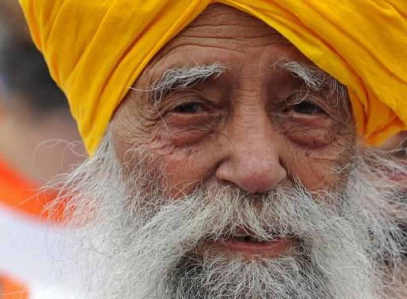 Indian-born British national Fauja Singh is pictured after crossing the finish line in the 10-km event as part of the Hong Kong Marathon on February 24, 2013. The 101-year-old Sikh believed to be the world's oldest marathon runner said on February 21 after arriving in the southern Chinese territory that he felt sad to be retiring from competitive events, as he prepared for his last race in Hong Kong.     AFP PHOTO / Dale de la Rey