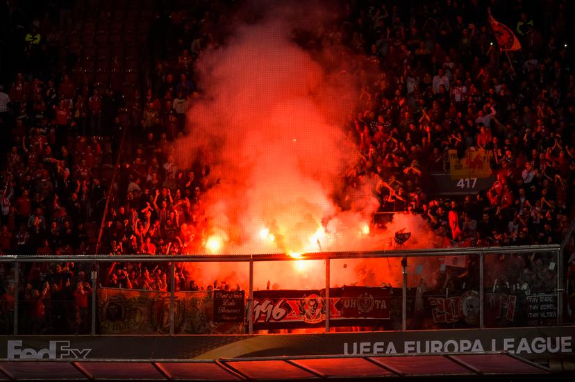 Standard's supporters pictured surrounded by smoke from fireworks during a game of the second day of the group stage of the Europa League competition between Dutch soccer team Ajax Amsterdam and Belgian club Standard de Liege, in Amsterdam, The Netherlands, Thursday 29 September 2016. BELGA PHOTO NICOLAS LAMBERT