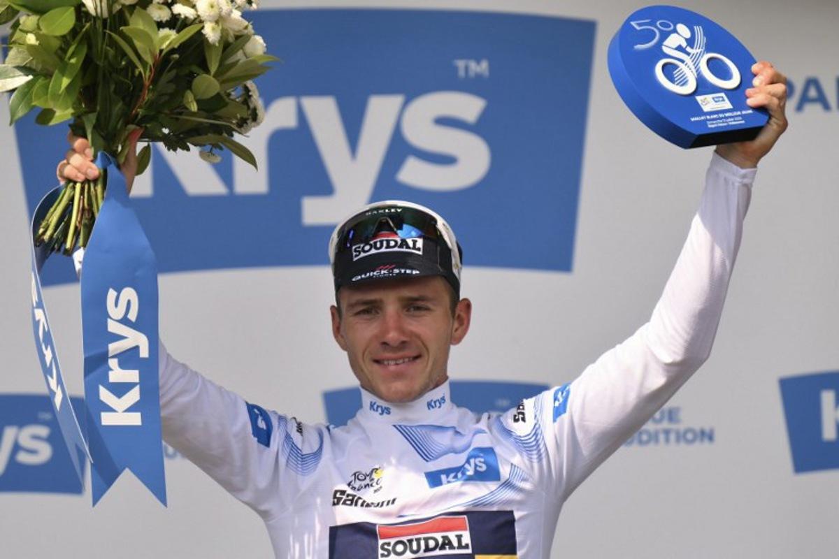 Soudal Quick-Step team's Belgian rider Remco Evenepoel celebrates on the podium with the best young rider's white jersey after the 9th stage of the 112th edition of the Tour de France cycling race, 174.1 km between Chinon and Chateauroux, central France, on July 13, 2025.  Marco BERTORELLO / AFP