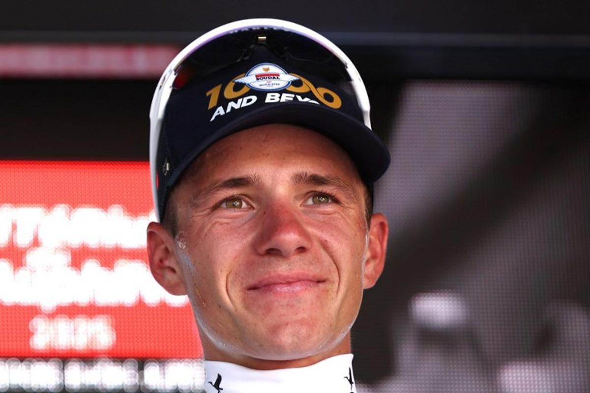Soudal Quick-Step's Belgian rider Remco Evenepoel celebrates wearing the best young rider's white jersey after winning the stage on the podium of the 4th stage of the 77th edition of the Criterium du Dauphine cycling race, a 17,4 km individual time trial between Charmes-sur-Rhône and Saint-Péray, on June 11, 2025.  Anne-Christine POUJOULAT / AFP