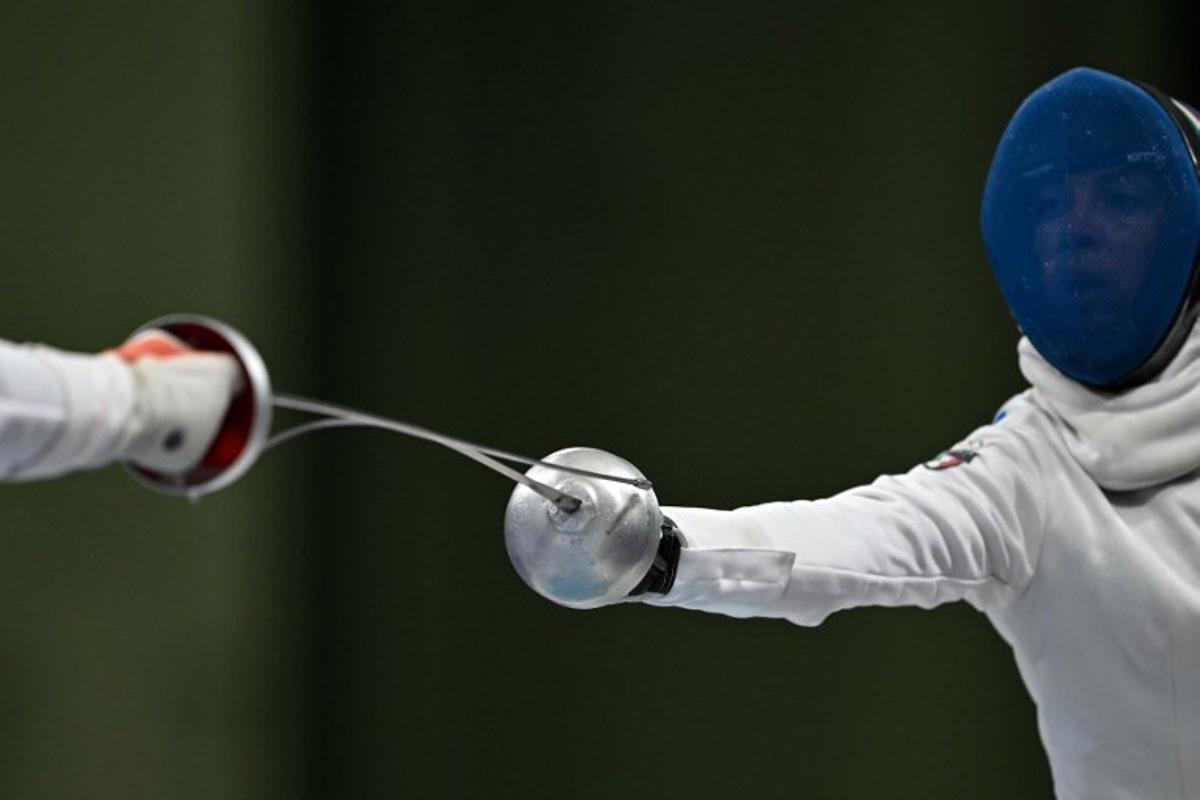China's Tang Junyao and Italy's Alberta Santuccio compete in the women's epee team semi-final bout during the Paris 2024 Olympic Games at the Grand Palais in Paris, on July 30, 2024.  Fabrice COFFRINI / AFP
