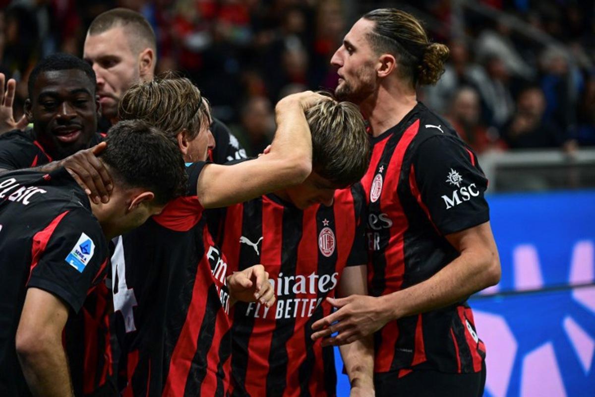 AC Milan's Begian midfielder #56 Alexis Saelemaekers (2nd R) is celebrated by his teammates after scoring his team's opening goal during the Italian Serie A football match between AC Milan and SSC Napoli at San Siro stadium in Milan, northern Italy, on September 28, 2025.  Piero CRUCIATTI / AFP