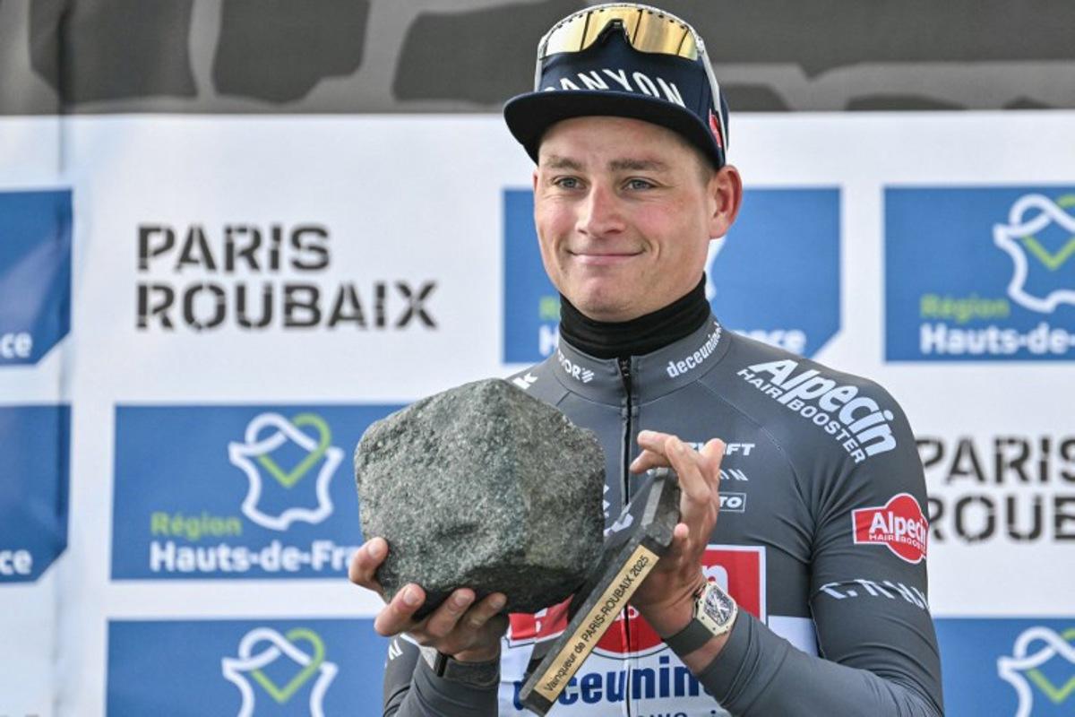 First placed Alpecin-Deceuninck's Dutch rider Mathieu van der Poel celebrates with his award on the podium of the 122nd edition of the Paris-Roubaix one-day classic cycling race, 259,2 km between Compiegne and Roubaix, northern France on April 13, 2025.  Jeff PACHOUD / AFP