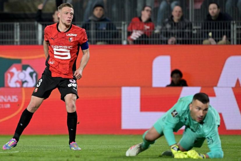 Rennes' French defender #03 Adrien Truffert (L) scores his team's first goal during the French L1 football match between Stade Rennais FC and FC Nantes at Roazhon Park stadium in Rennes, western France on April 18, 2025.  DAMIEN MEYER / AFP
