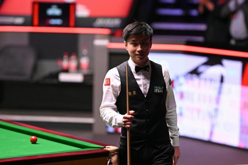 China's Zhao Xintong reacts having lost the first four frames of the final session, on day two of his World Championship Snooker final against Wales' Mark Williams at The Crucible in Sheffield, northern England on May 5, 2025.   Oli SCARFF / AFP