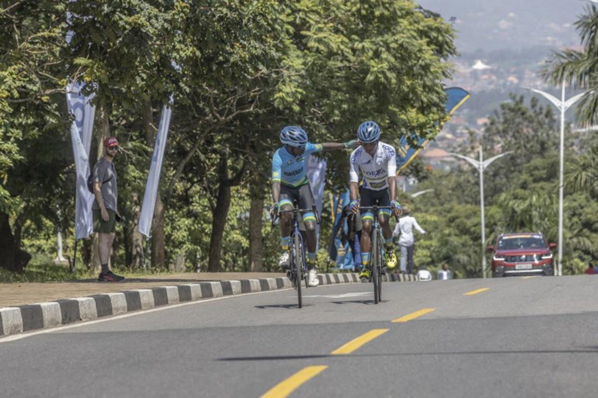 Rwanda National Team's Rwandan rider Samuel Niyonkuru (L) and Rwanda National Team's Rwandan rider Eric Manizabayo (R) interact together before the beginning of the final stage of the 16h Tour du Rwanda on 25 February 2024, in Kigali. Israel Premier Tech's British rider Joseph Blackmore, won the Tour of Rwanda which ended on Sunday in the capital Kigali.  Guillem Sartorio / AFP