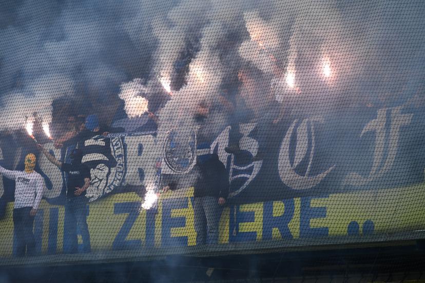 Supporters with fireworks and smoke bombs pictured during a soccer match between Sint-Truidense V.V. and KRC Genk, Sunday 28 September 2025 in Sint-Truiden, on day 9 of the 2025-2026 'Jupiler Pro League' first division of the Belgian championship. BELGA PHOTO JILL DELSAUX