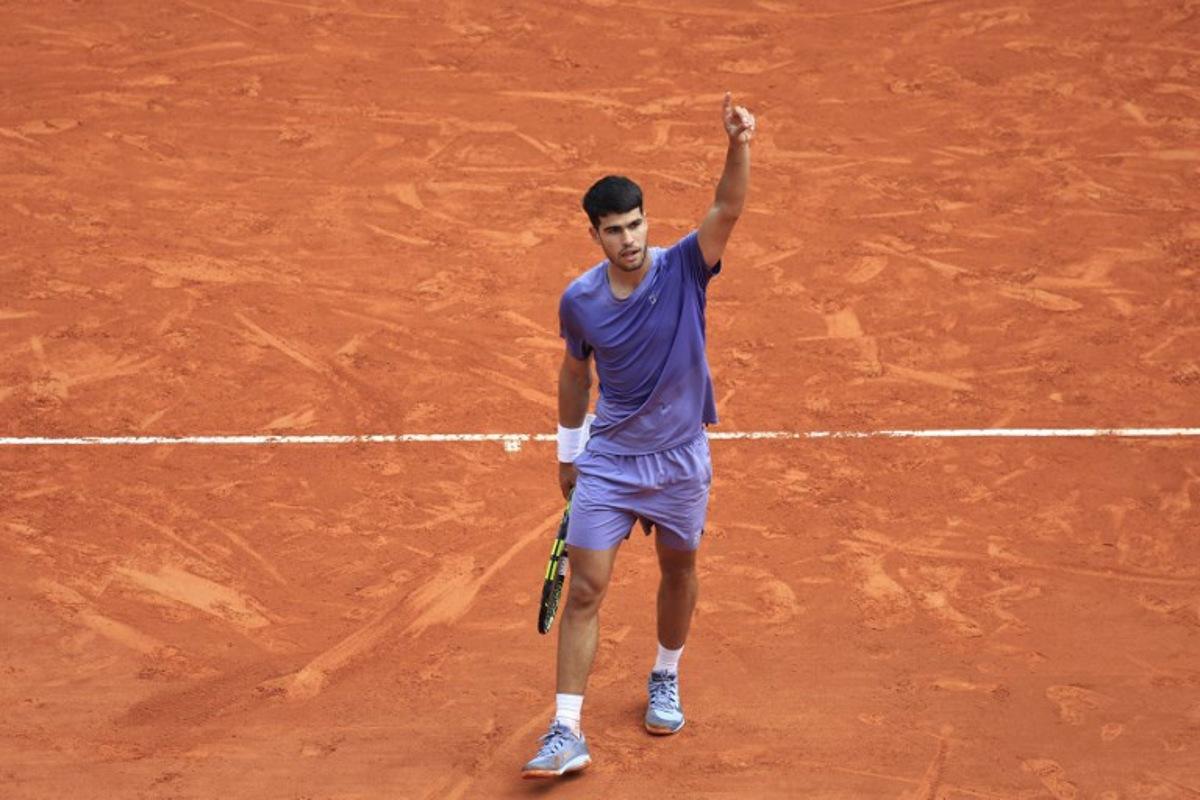 Spain's Carlos Alcaraz reacts after a point as he plays against France's Arthur Fils during the Monte Carlo ATP Masters Series Tournament quarter-final tennis match on the Rainier III court at the Monte Carlo Country Club in Roquebrune-Cap-Martin on April 11, 2025.  Valery HACHE / AFP