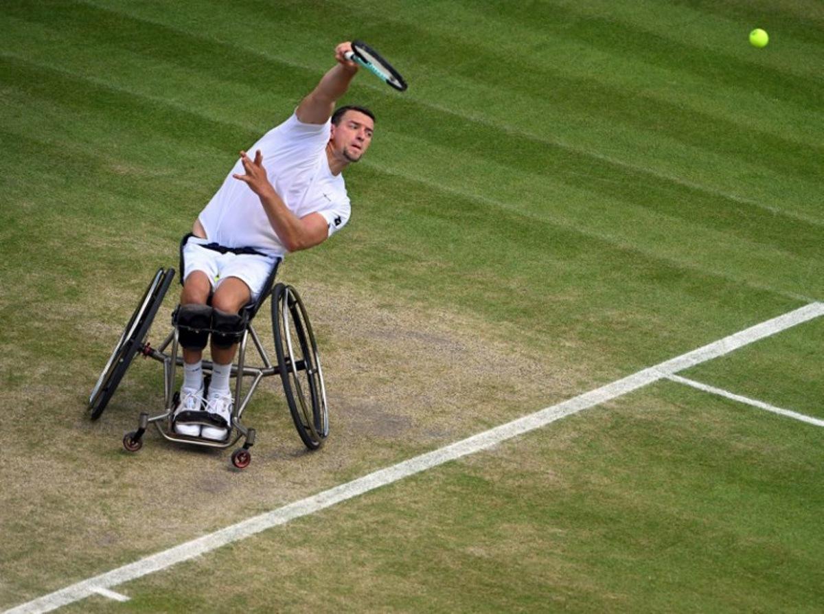 Belgium's Joachim Gerard serves against Japan's Shingo Kunieda during their men's weelchair singles semi final tennis match on the twelfth day of the 2022 Wimbledon Championships at The All England Tennis Club in Wimbledon, southwest London, on July 8, 2022.   SEBASTIEN BOZON / AFP