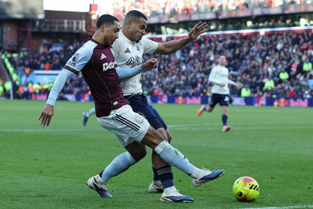Aston Villa's Belgian midfielder  #08 Youri Tielemans (L) vies with Nottingham Forest's Brazilian defender #05 Murillo (R) during the English Premier League football match between Aston Villa and Nottingham Forest at Villa Park in Birmingham, central England on January 3, 2026.  Darren Staples / AFP