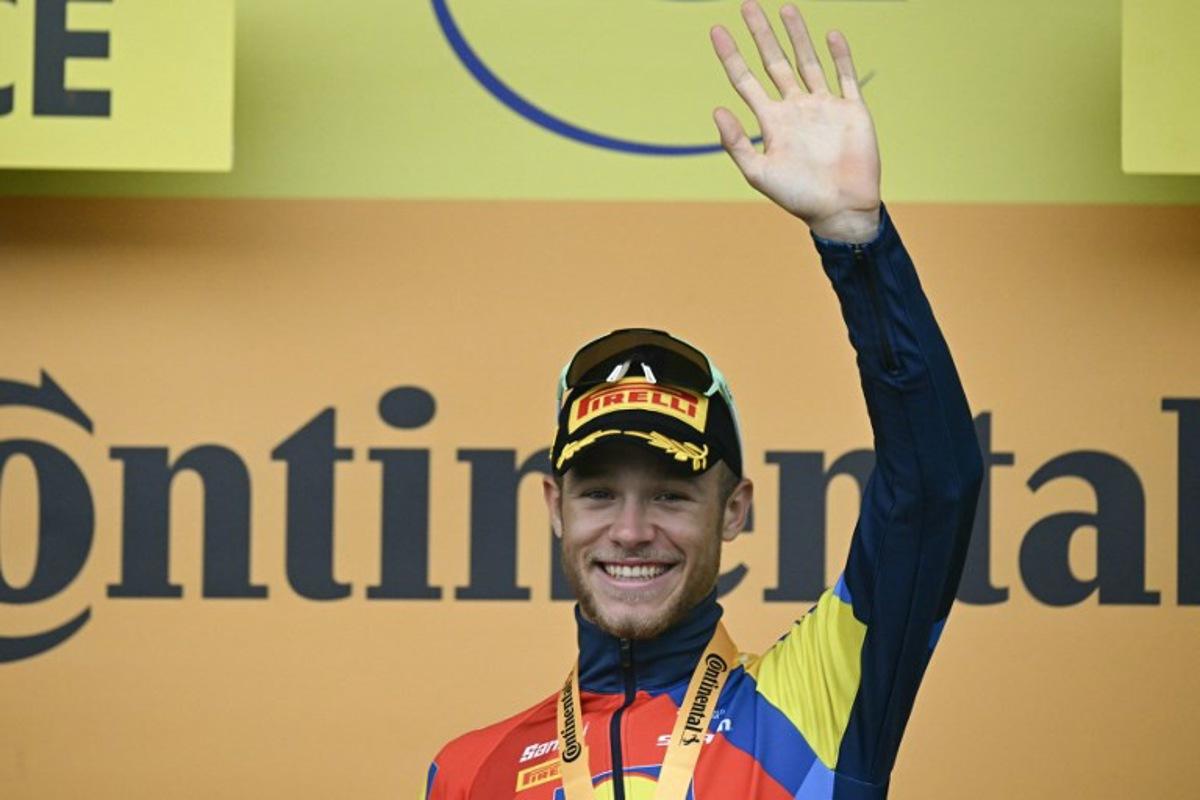 Lidl - Trek team's Italian rider Jonathan Milan celebrates on the podium after winning the 17th stage of the 112th edition of the Tour de France cycling race, 160.4 km between Bollene and Valence, southern France, on July 23, 2025.  Loic VENANCE / AFP