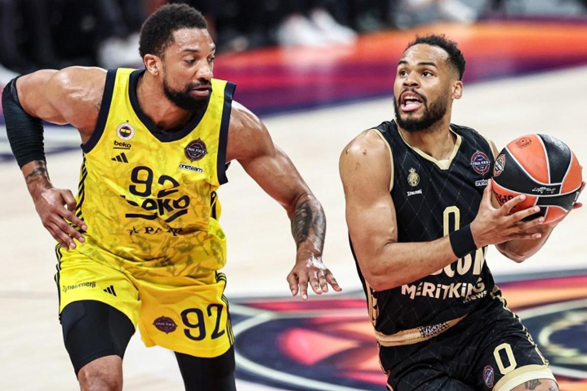 Fenerbahce's Canadian center #92 Khem Birch marks AS Monaco's French guard #0 Elie Okobo during the Euroleague Basketball final match between Fenerbahce Beko Istanbul and AS Monaco at Etihad Arena in Abu Dhabi on May 25, 2025.  Fadel SENNA / AFP