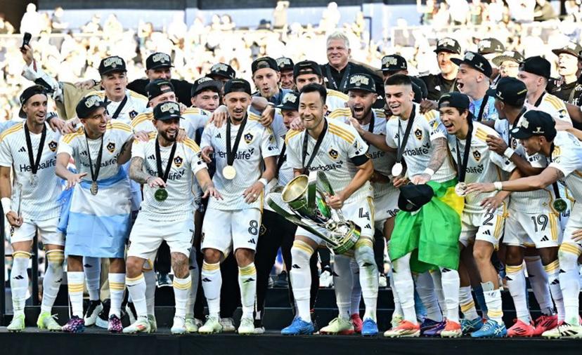 LA Galaxy's captain Japanese defender #04 Maya Yoshida prepares to lift the trophy as he celebrates with teammates following the Major League Soccer (MLS) Cup Final match between the LA Galaxy and the NY Red Bulls at the Dignity Health Sports Park in Carson, California, on December 7, 2024.    Frederic J. BROWN / AFP