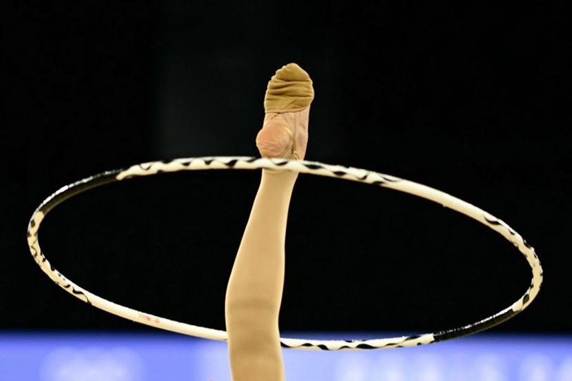 Romania's Annaliese Dragan performs with the hoop as she competes in the rhytmic gymnastics' individual all-around qualification during the Paris 2024 Olympic Games at the Porte de la Chapelle Arena in Paris, on August 8, 2024.  Loic VENANCE / AFP