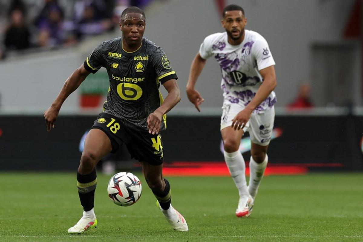 Lille's French defender #18 Bafode Diakite (L) controls the ball during the French L1 football match between Toulouse FC and Lille OSC at The TFC Stadium in Toulouse, southwestern France, on April 12, 2025.  Valentine CHAPUIS / AFP