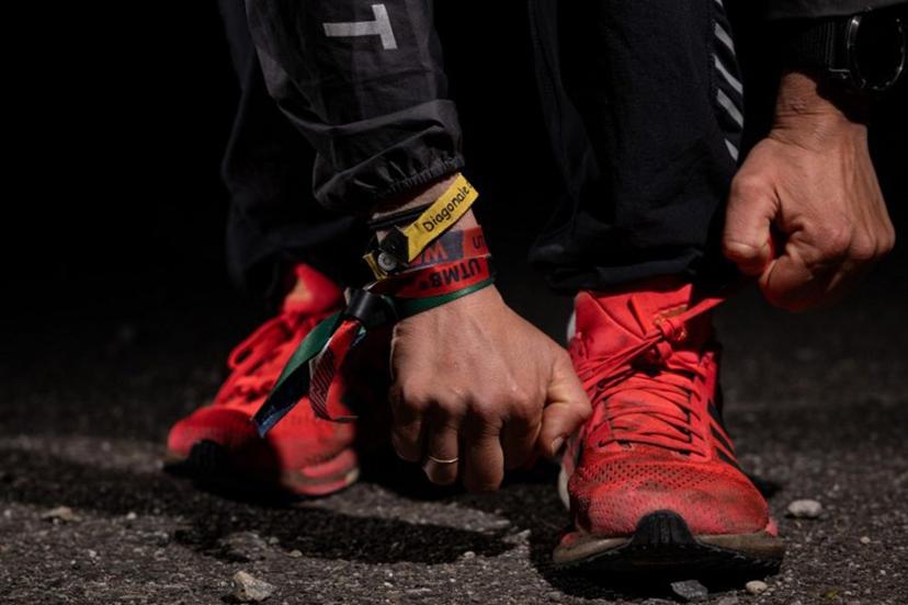 French runner Claire Bannwarth puts on her shoes during a training session in Saint-Louis, eastern France, on April 18, 2024. "My connected watch often tells me to take a break". An atypical ultra-trail phenomenon, France's Claire Bannwarth spends most of her time running, very slowly, and her vacations winning the world's toughest races. SEBASTIEN BOZON / AFP