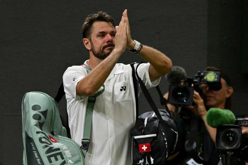 Switzerland's Stan Wawrinka gestures to the crowd as he leaves following his defeat to Italy's Matteo Berrettini during their men's singles first round tennis match on the second day of the 2026 Wimbledon Championships at The All England Lawn Tennis and Croquet Club in Wimbledon, southwest London, on June 30, 2026.  Glyn KIRK / AFP