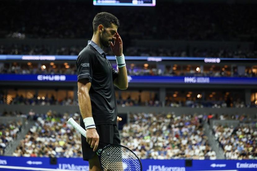 Serbia's Novak Djokovic reacts during a match against Argentina's Mariano Navone during the men's singles first round tennis match on day one of the US Open tennis tournament at the USTA Billie Jean King National Tennis Center in New York City on August 30, 2026.  CHARLY TRIBALLEAU / AFP