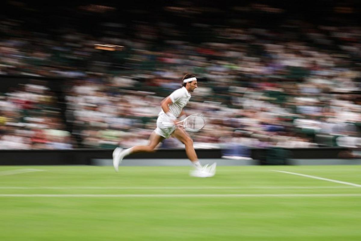 France's Arthur Rinderknech runs for the ball to Germany's Alexander Zverev during their men's singles first round tennis match on the first day of the 2025 Wimbledon Championships at The All England Lawn Tennis and Croquet Club in Wimbledon, southwest London, on June 30, 2025.  HENRY NICHOLLS / AFP