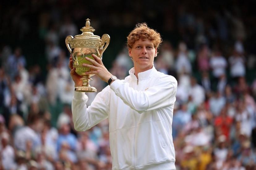 Italy's Jannik Sinner celebrates with the winner's trophy as he poses for pictures following his victory against Spain's Carlos Alcaraz at the end of their men's singles final tennis match on the fourteenth day of the 2025 Wimbledon Championships at The All England Lawn Tennis and Croquet Club in Wimbledon, southwest London, on July 13, 2025.  HENRY NICHOLLS / AFP